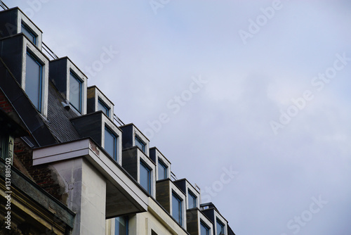 Several dormer windows on a roof.