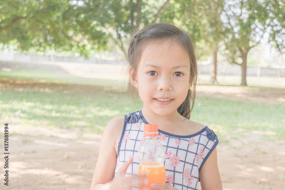 Asian girl drinking orange juice . Asian girl drinking orange juice .