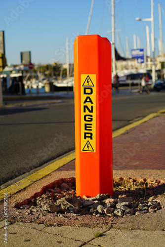 A danger sign on the pavement.