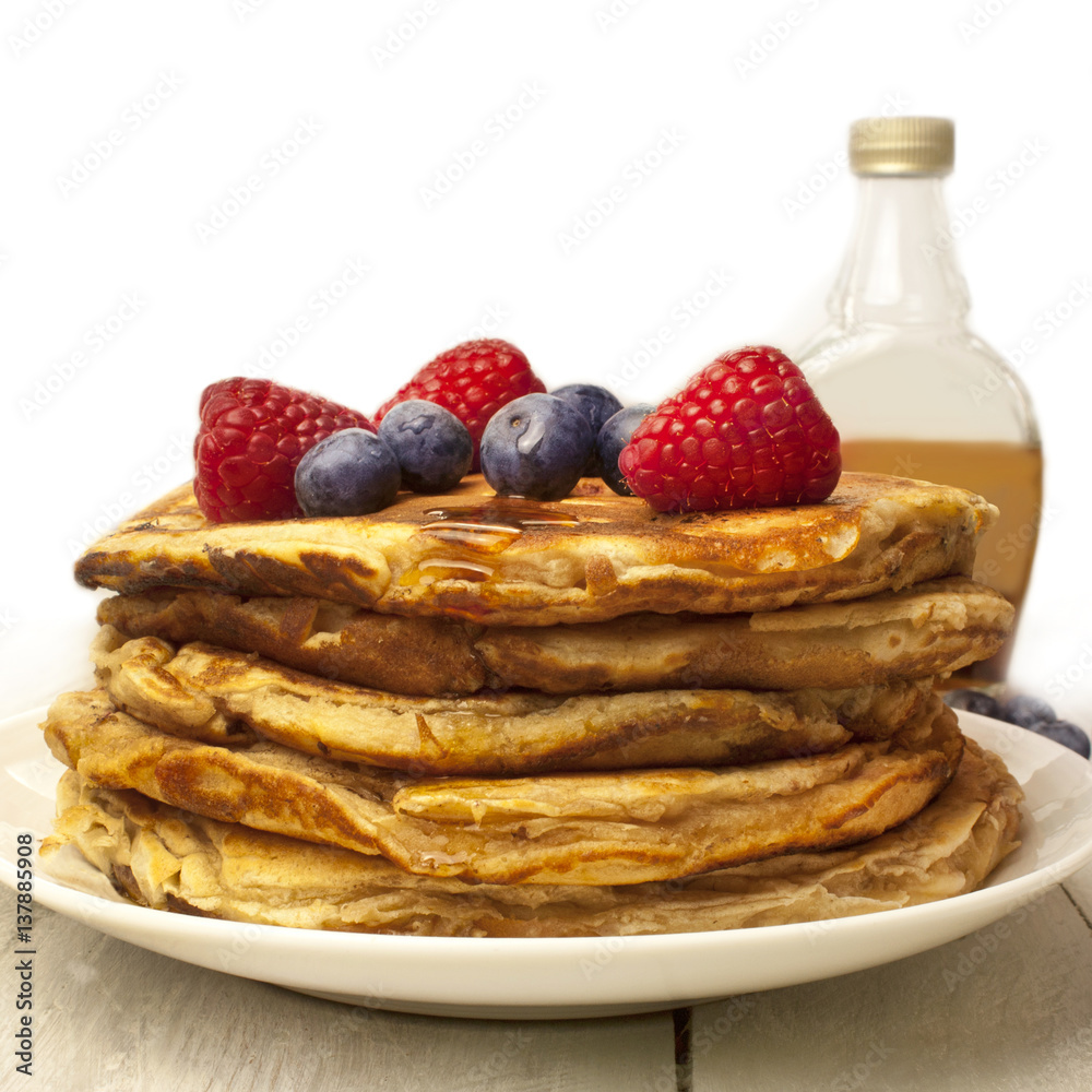 Stack of homemade pancackes with generic maple syrup bottle Stack of homemade pancackes with generic maple syrup bottle