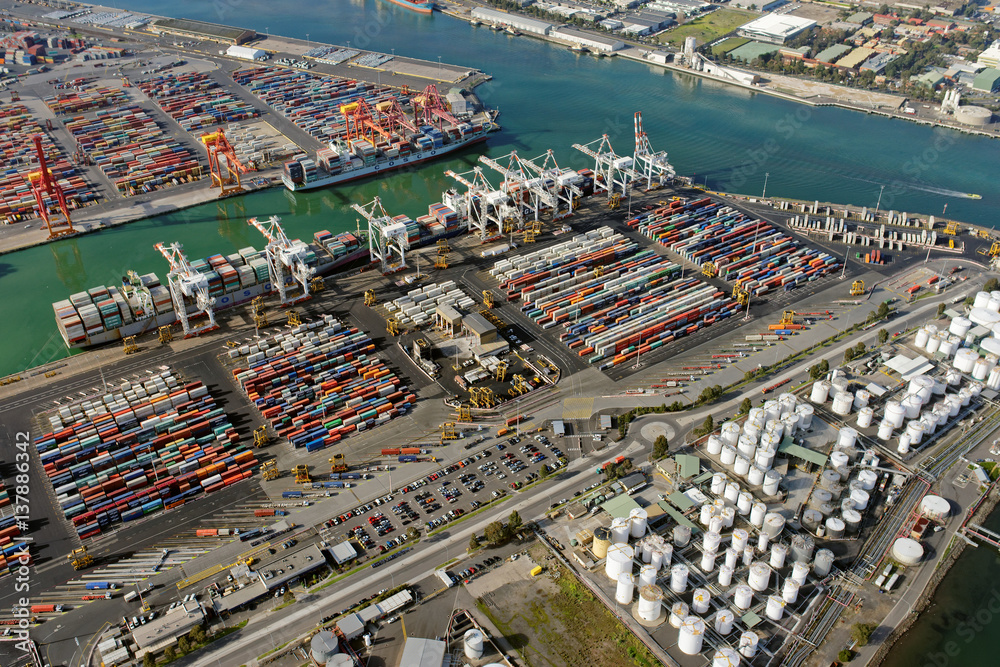 Obraz premium Aerial view of shipping containers, cranes and storage tanks in Melbourne, Australia