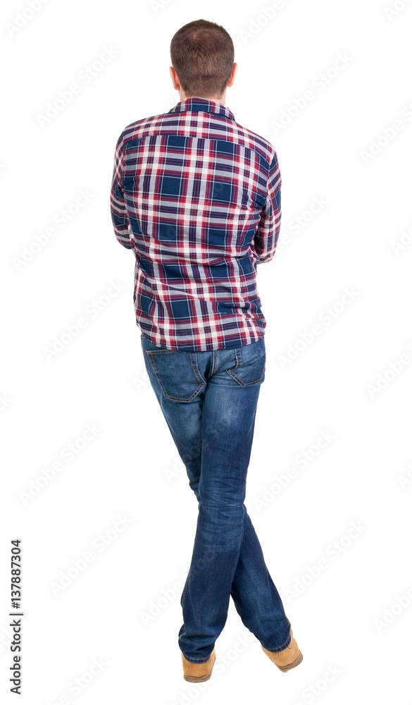 Back view of handsome man in checkered shirt looking up. Back view of handsome man in checkered shirt looking up.