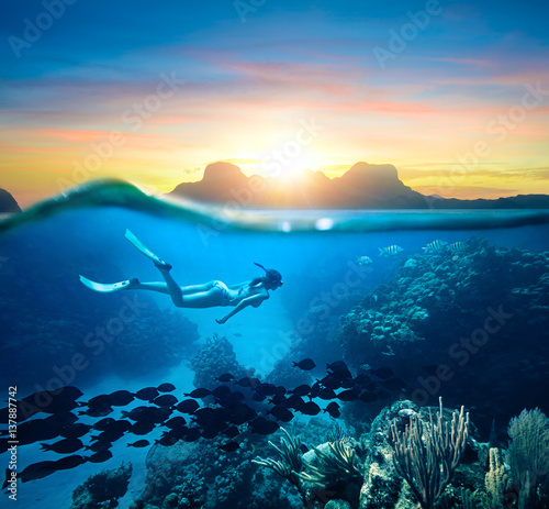 Woman snorkeling in clear tropical waters ocean on sunset day