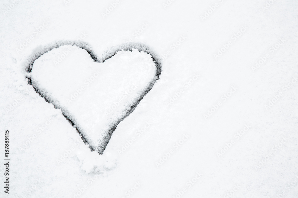 Heart drawn in the fresh snow. Winter day. Valentine's Day.