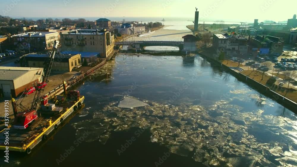 Manitowoc River in rare mid February thaw. The ice is already broken, aerial view.
Manitowoc River in rare mid February thaw. The ice is already broken, aerial view.