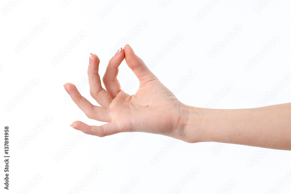 female hand outstretched to the side and showing the gesture with the fingers is isolated on a white background