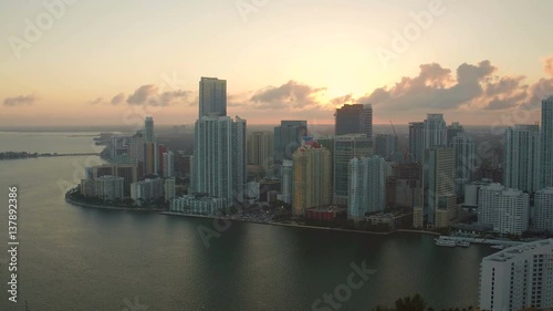 Miami Aerial v35 Flying over bay panning with cityscape views at sunset. photo