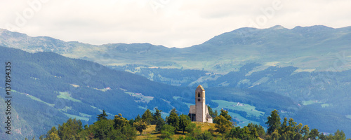 Medieval church on top of the hill, Italian Alps photo