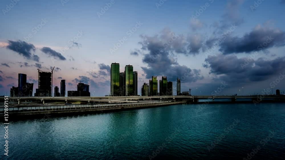 Timelapse of clouds floating above modern buildings at evening, Abu Dhabi, UAE
Timelapse of clouds floating above modern buildings at evening, Abu Dhabi, UAE