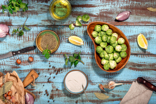 Raw brussels sprouts with ingredients for cooking healthy food