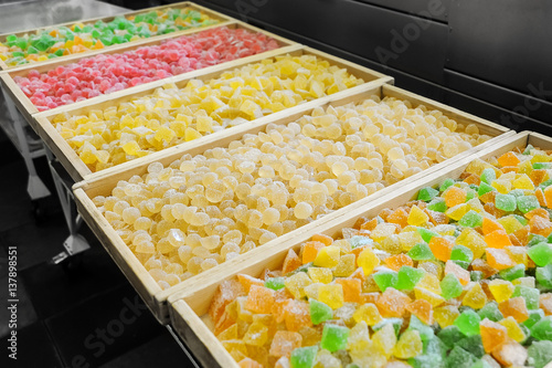 Sweet fresh colorful fruit candy at the confectionery factory ready for sale