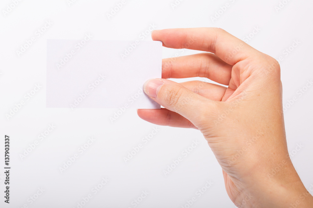 Obraz premium Female hand holding blank card isolated