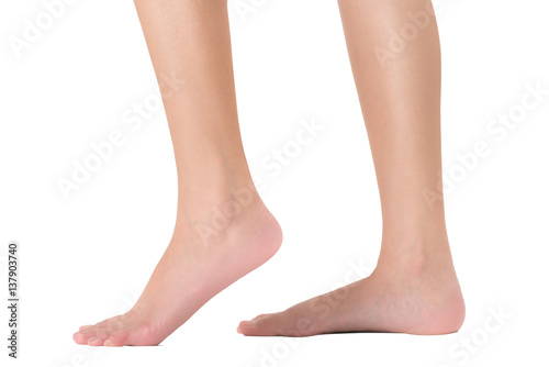 Side view of woman's feet in walking pose, Isolated on white background. © kintarapong