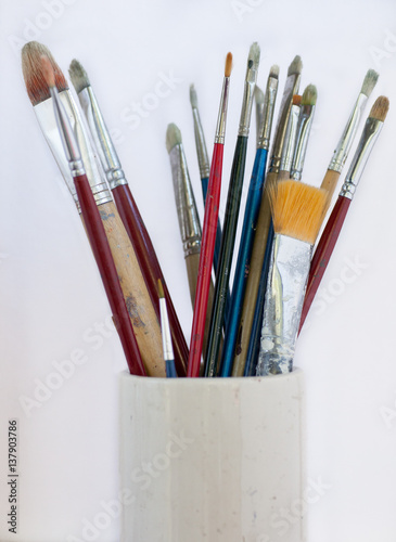 Collection of artist brushes in pottery vase