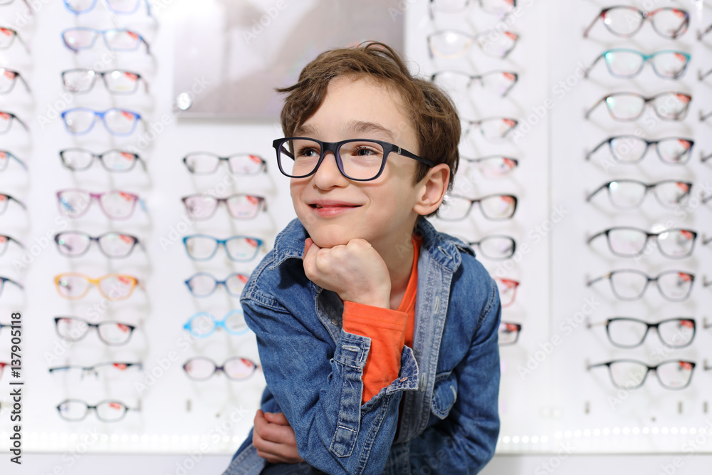 boy in glasses , at optics store
