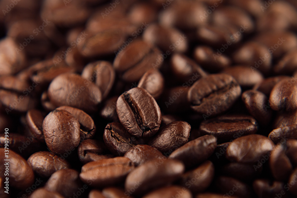 Roasted coffee beans closeup top view as background. Roasted coffee beans closeup top view as background.