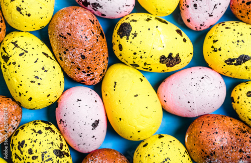 Texture with easter eggs on wooden background, overhead
