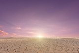Soil drought cracked landscape on sunset sky background