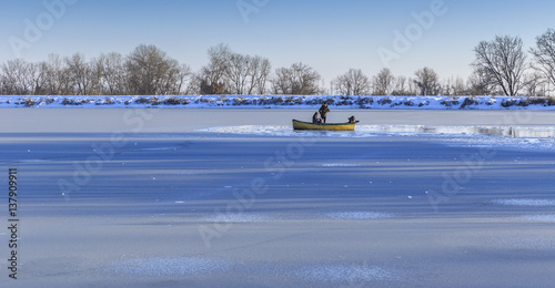 Young couple and photographer in a boat on a frozen lake Nohur.Gabala.Azerbaijan photo