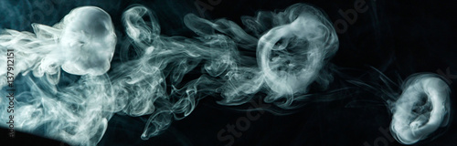 Vape trick smoke ring on dark background