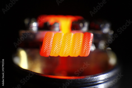 Burning alien coil build on vaping rebuildable dripping atomizer