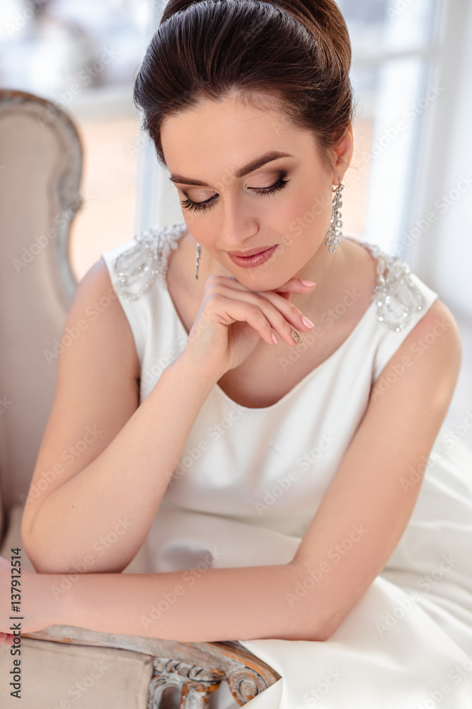 close-up portrait of beautiful brunette bride with elegant hairstyle and makeup wearing long luxury wedding dress close-up portrait of beautiful brunette bride with elegant hairstyle and makeup wearing long luxury wedding dress