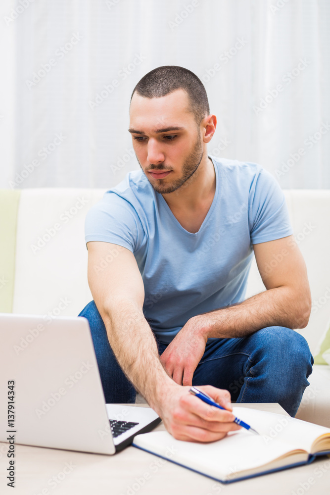 Young businessman working at home. Young businessman working at home.