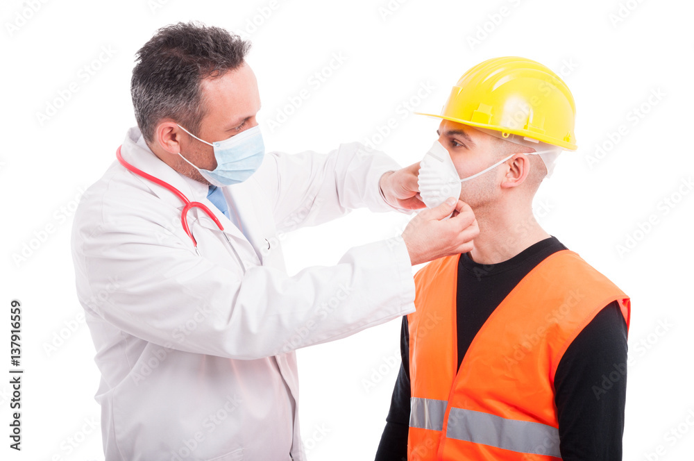 Male doctor arranging mark on constructor face Male doctor arranging mark on constructor face