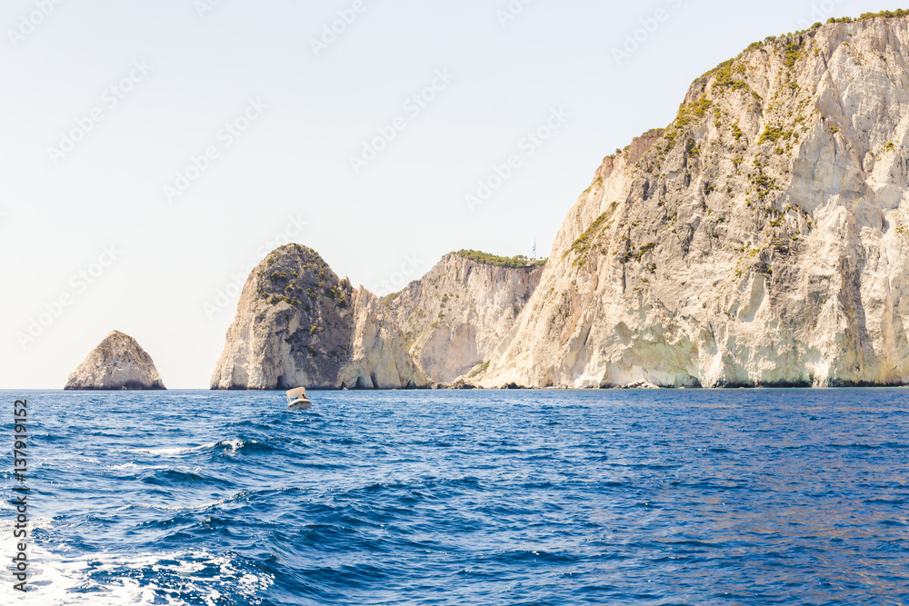 Cruise around Zakynthos, landscape view from the sea on the island, Greece. small motor boat rocking by waves