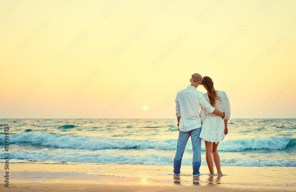 Young loving couple on the sea beach.