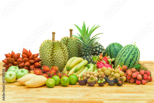 Fresh mixed fruits on wood table isolated on white background.