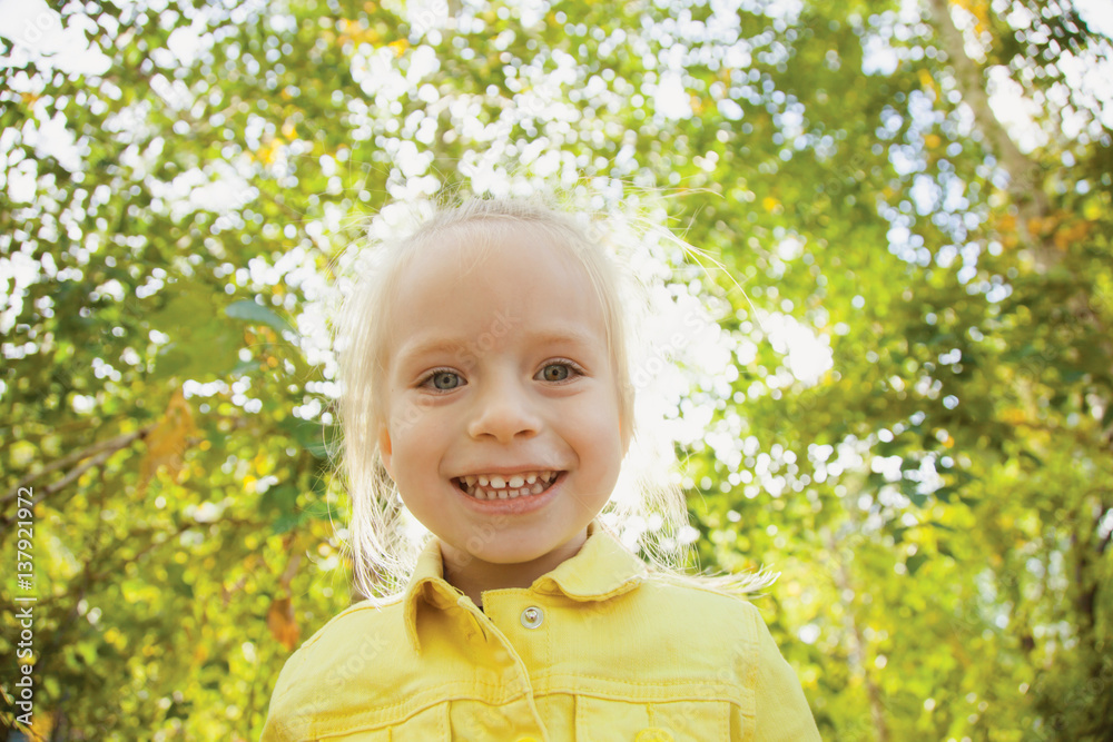 Smiling happy toddler girl. Sunny Autumn day Smiling happy toddler girl. Sunny Autumn day