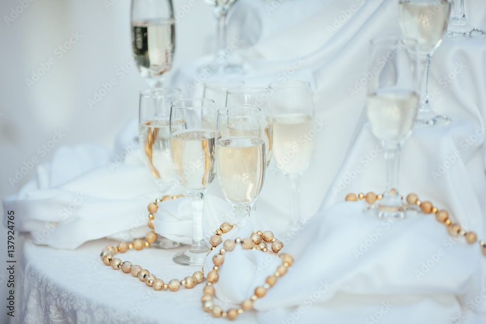 Dish with champagne and wine glasses. On outdoor wedding reception in summer. Dish with champagne and wine glasses. On outdoor wedding reception in summer.