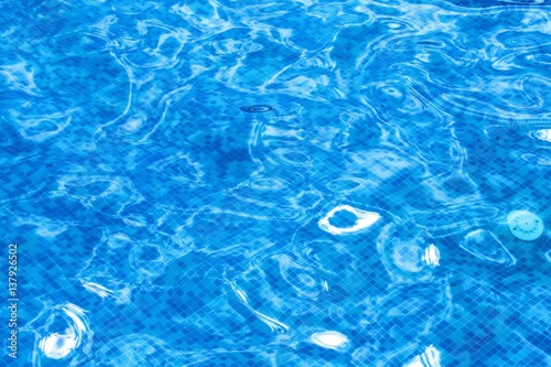 Blue ripped water in swimming pool background.
