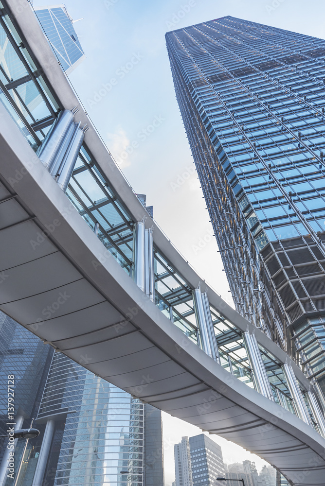 Modern office building and pedestrian walkway in Hong Kong city Modern office building and pedestrian walkway in Hong Kong city