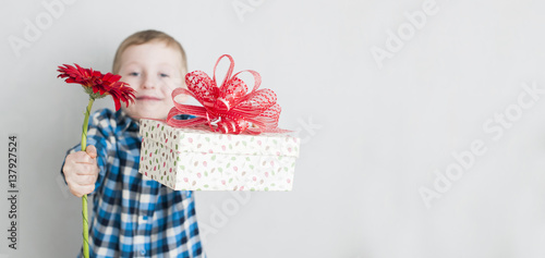 little boy with red flower and gift box