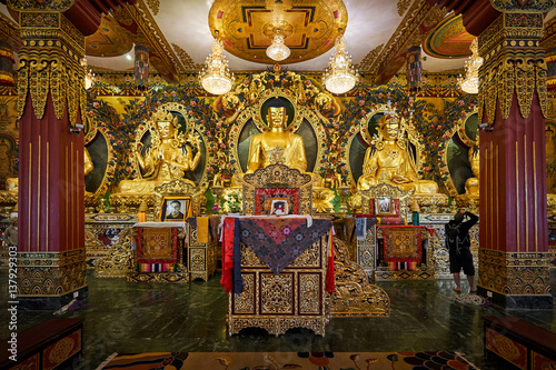 Golden buddha statues in the modern tibetan monastery in Dakshinkali, Nepal © vladimirzhoga