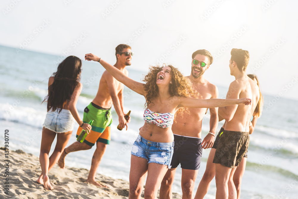 Multiracial group of friends having a party on the beach Multiracial group of friends having a party on the beach