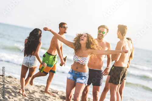 Multiracial group of friends having a party on the beach