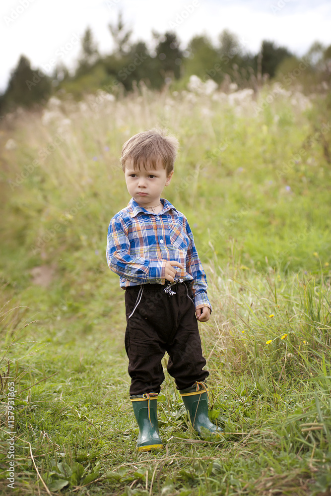 Children in the village walk in the tall grass Children in the village walk in the tall grass