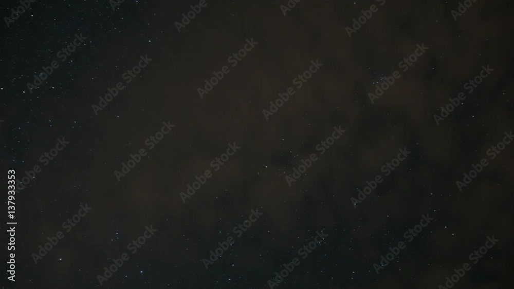 Dark sky full of stars and clouds passing by time lapse scene