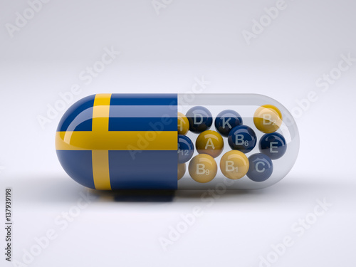 Pill with Swedish flag wrapped around it and red ball inside photo