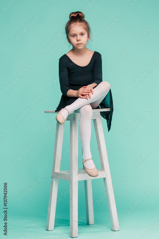 The little balerina dancer on blue background The little balerina dancer on blue background