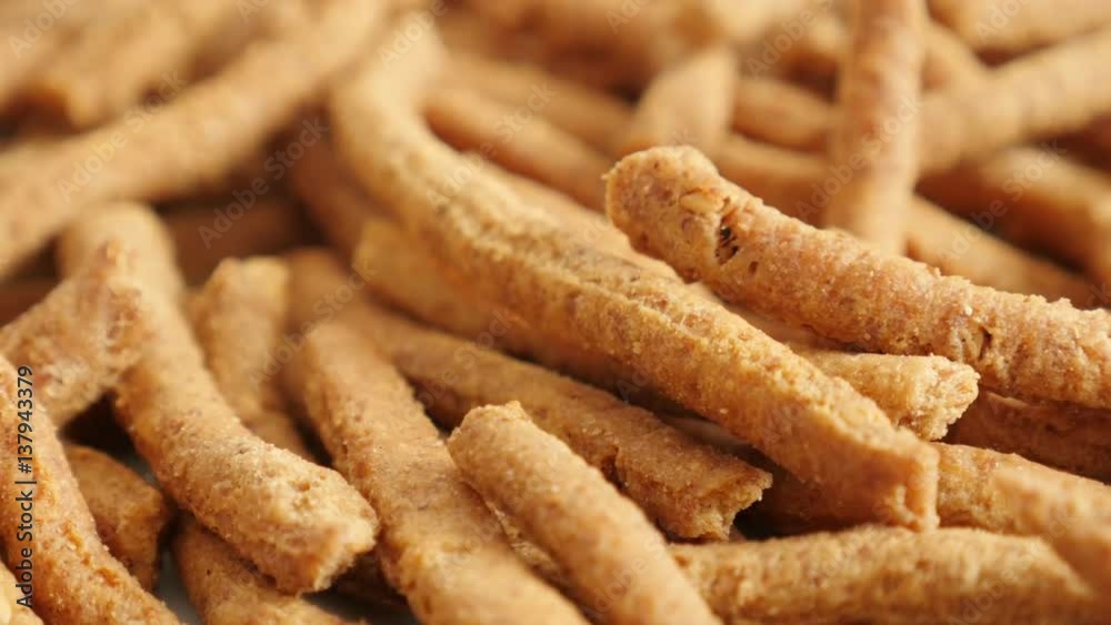 Shallow DOF tasty integral breadsticks snacks fried in oil slow tilt 4K 2160p 30fps UltraHD footage Shallow DOF tasty integral breadsticks snacks fried in oil slow tilt 4K 2160p 30fps UltraHD footage
