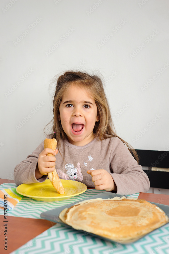 Young crazy girl eating a stack of pancakes. Young crazy girl eating a stack of pancakes.