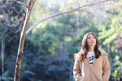 beautiful young woman with blooming cherry blossoms sakura flowers