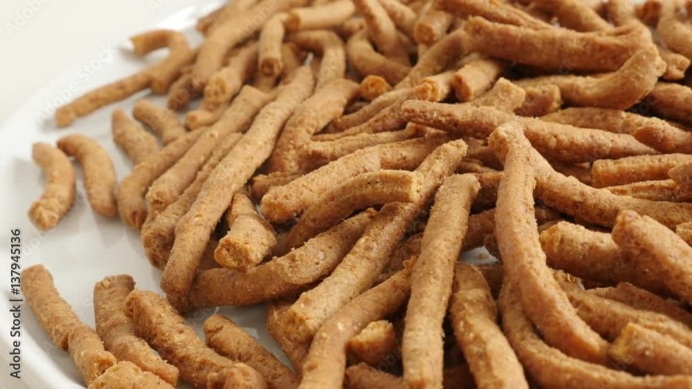 Pile of integral breadsticks snacks fried in oil slow pan 4K 2160p 30fps UltraHD footage Pile of integral breadsticks snacks fried in oil slow pan 4K 2160p 30fps UltraHD footage