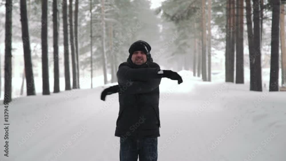 Portrait of a young handsome man with a beard. A bearded man in the winter woods. Healthy young bearded man in nature.