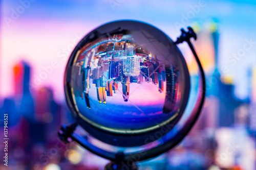 Crystal globe reflection cityscape building inside with blur background