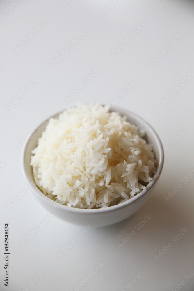 Cooked rice in bowl isolated in white background - obrazy, fototapety, plakaty 